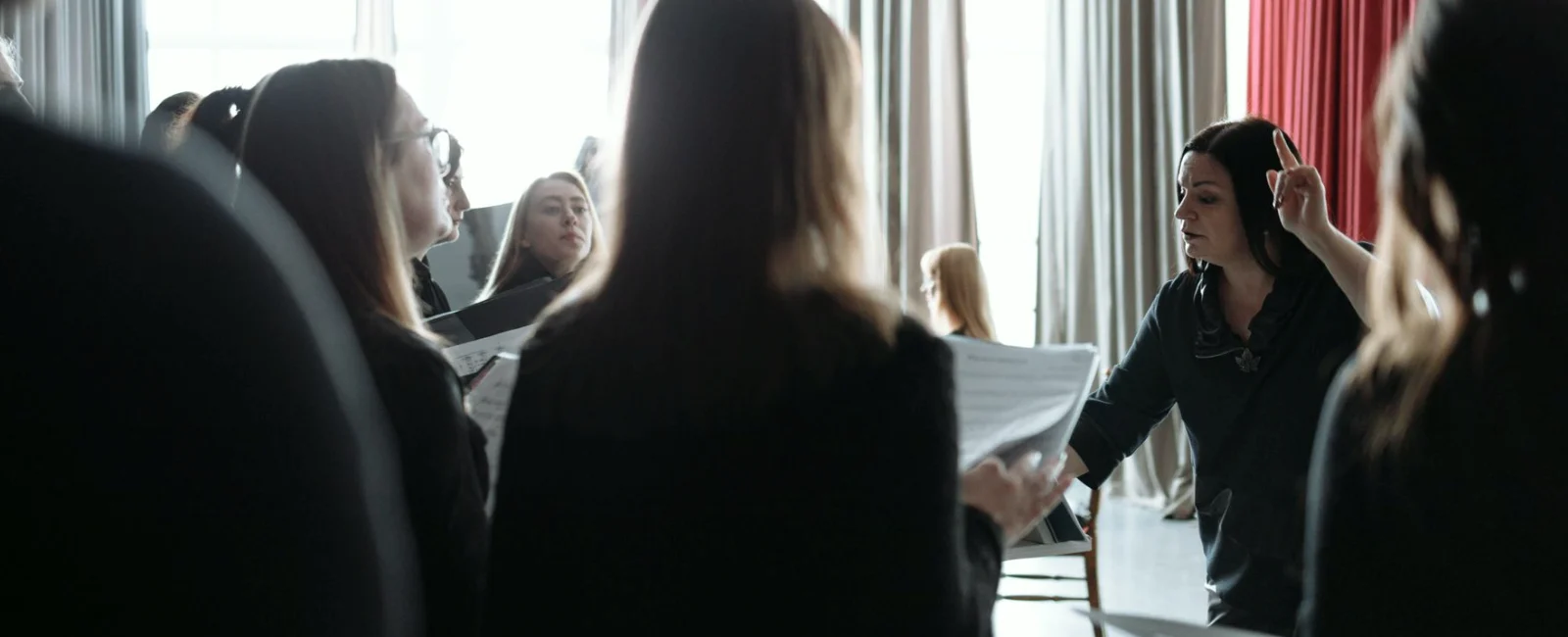 Learners rehearse a sample presentation while an instructor reviews the cue sheet